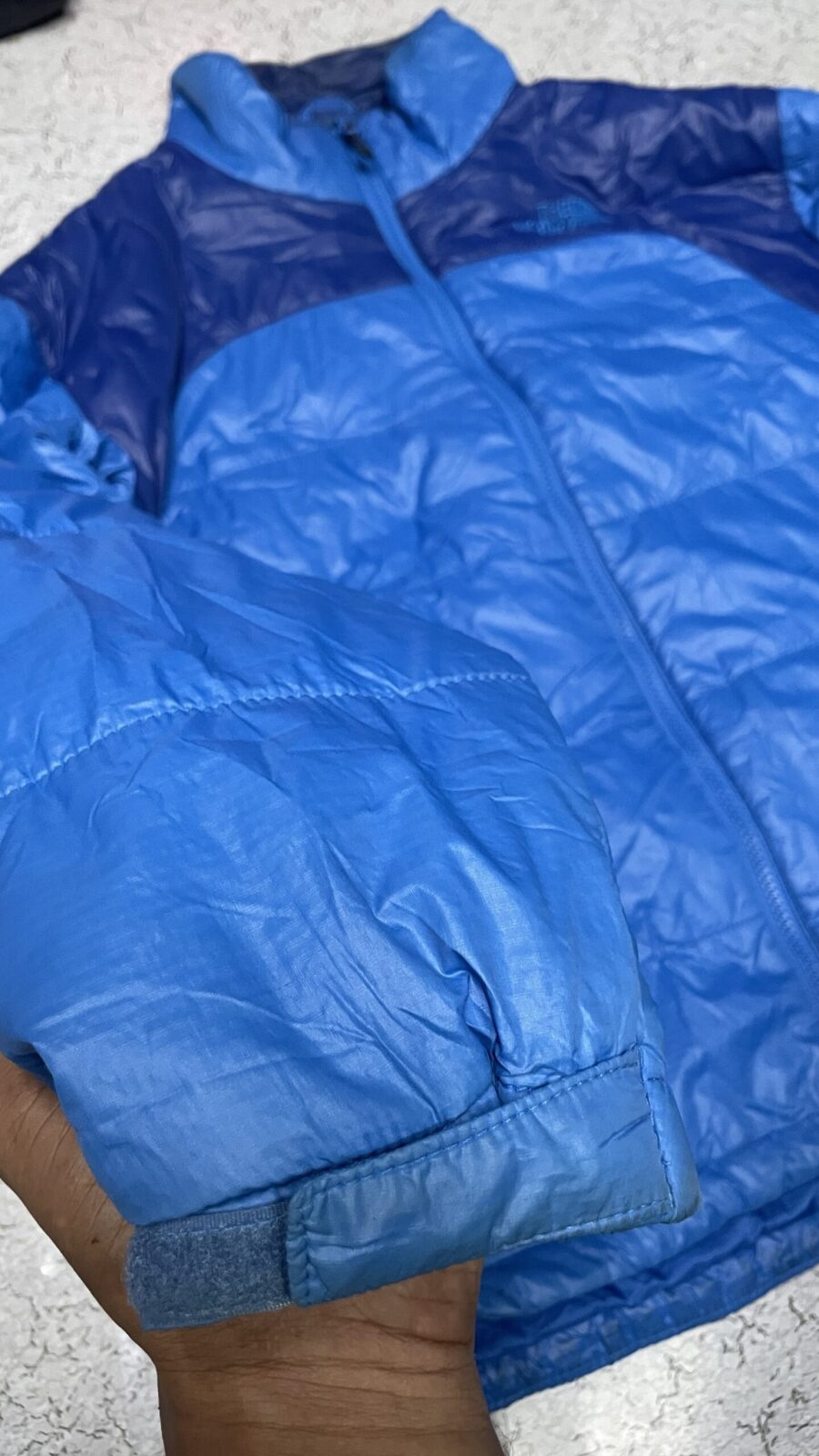 The North Face Blue Puffer Jacket detail view